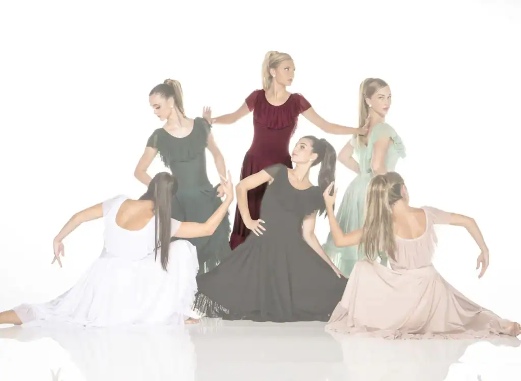 Six women in flowing dresses pose against a white background.