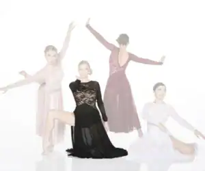 Four dancers posing in elegant flowing dresses