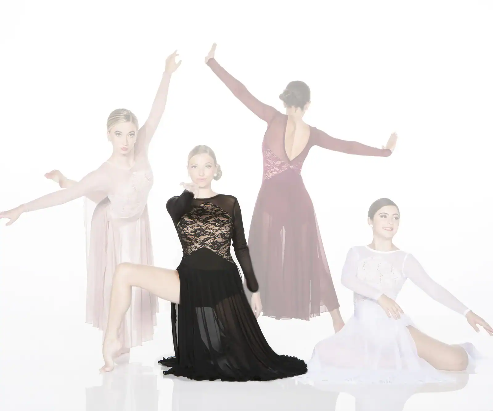 Four dancers posing in elegant flowing dresses