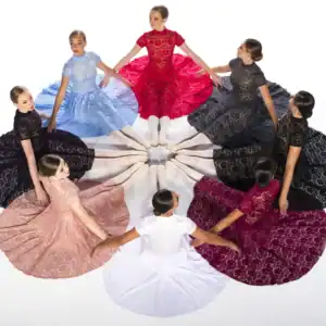 Ballerinas seated in a circle wearing colorful lace dresses