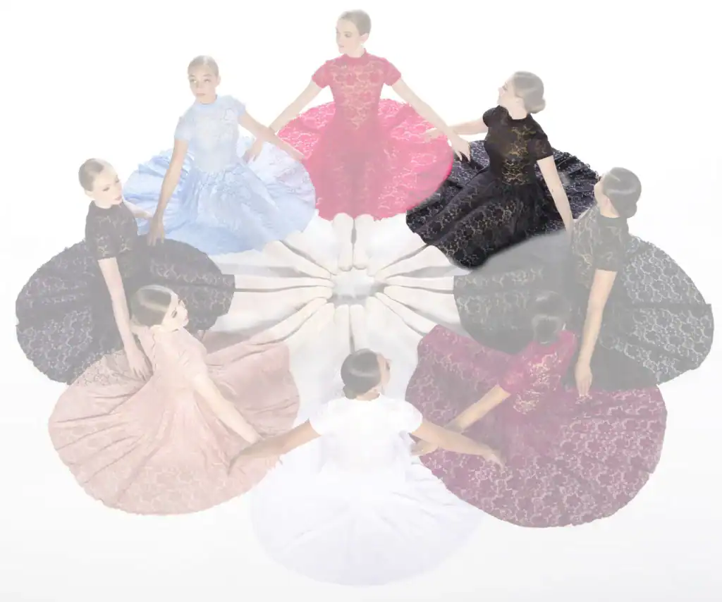 Women in colorful lace dresses seated in a circle