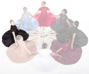 Women in colorful lace dresses seated in a circle