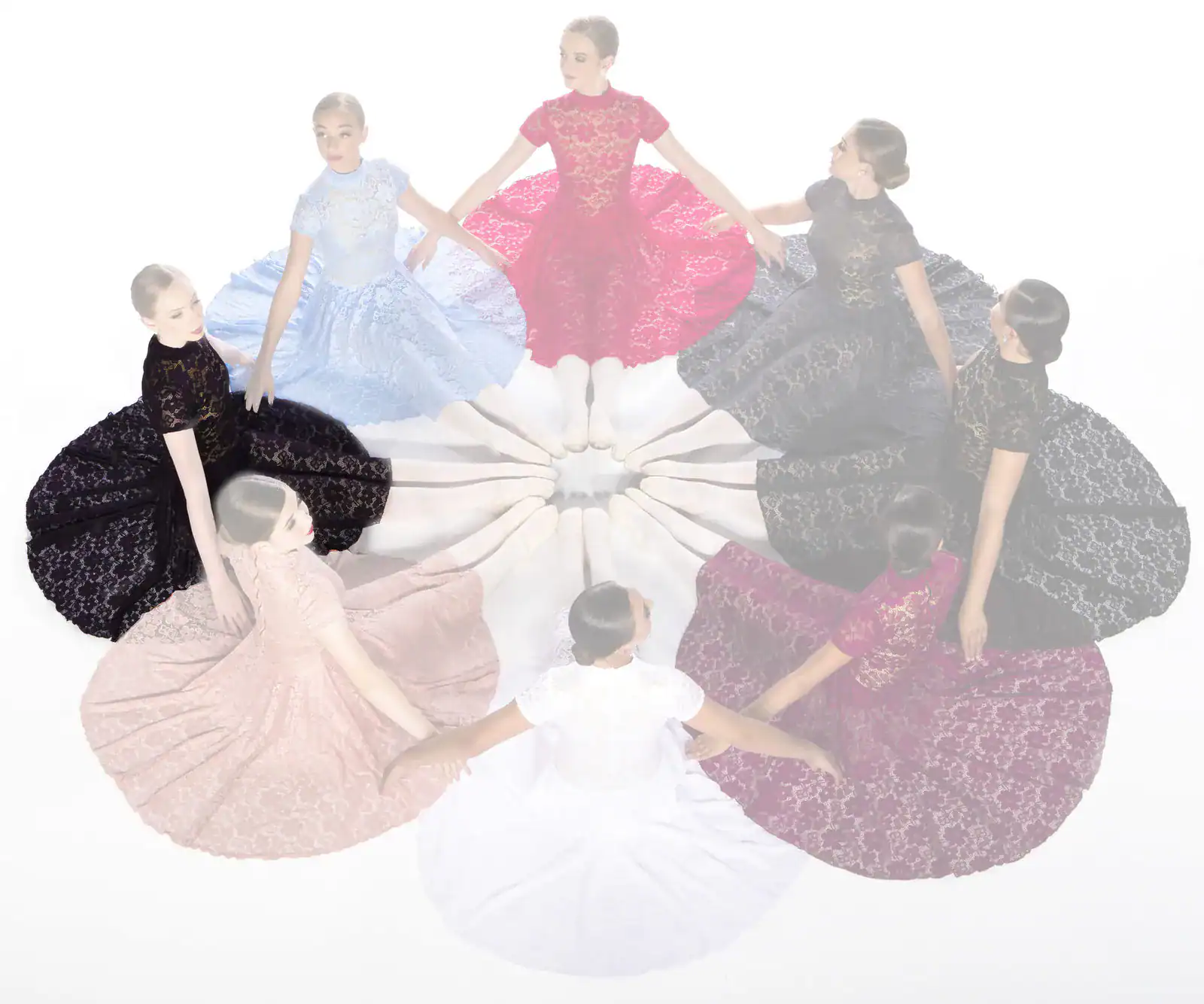 Women in colorful lace dresses seated in a circle