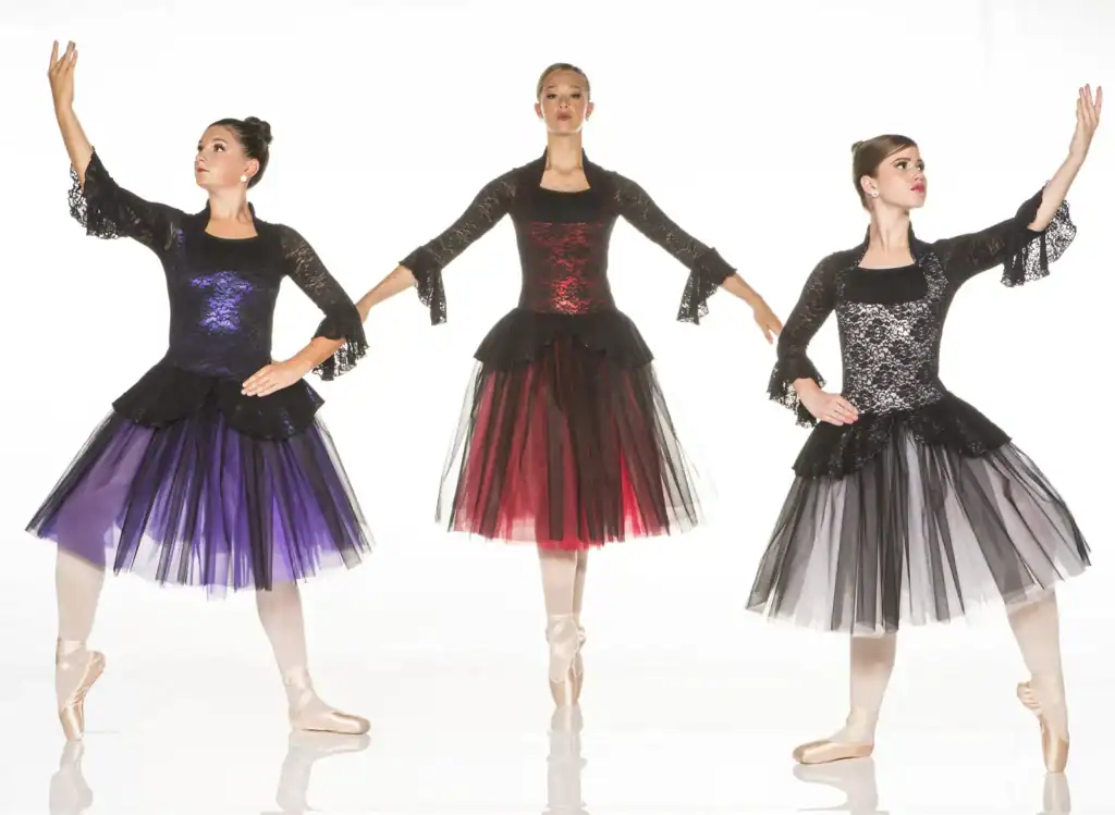 Three ballet dancers in colorful black lace dresses
