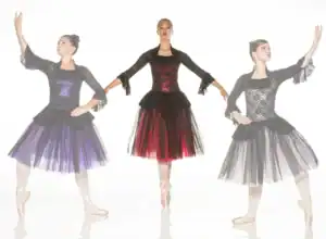 Three ballerinas in black lace dresses with colorful tulle skirts