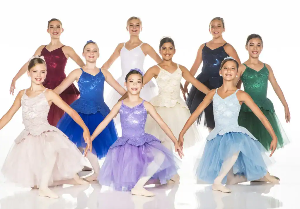 Young ballet dancers posing in colorful dresses