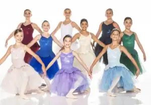 Young ballet dancers posing in colorful dresses