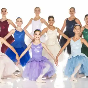 Young ballet dancers posing in colorful dresses