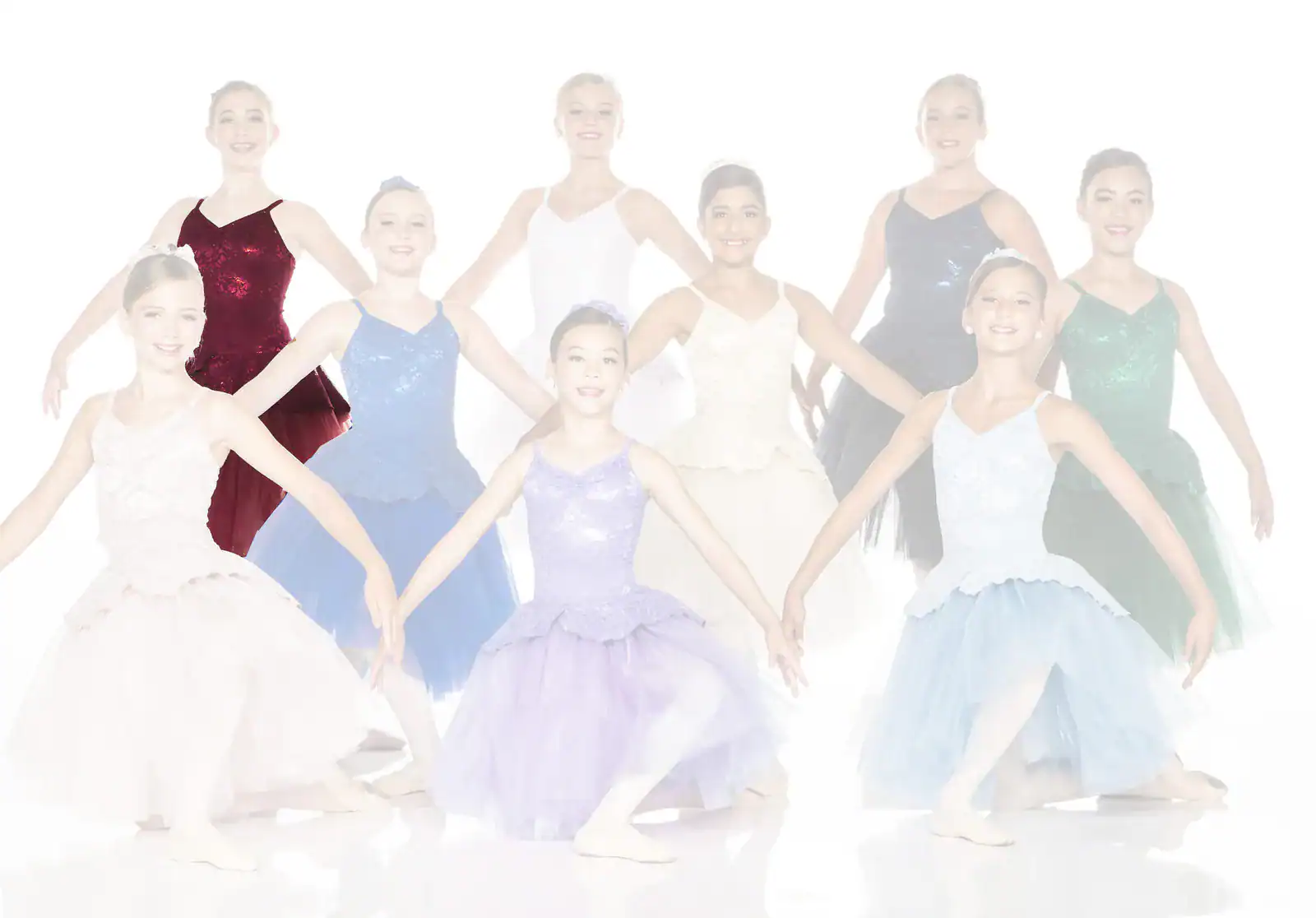 Young ballet dancers in colorful costumes posing together