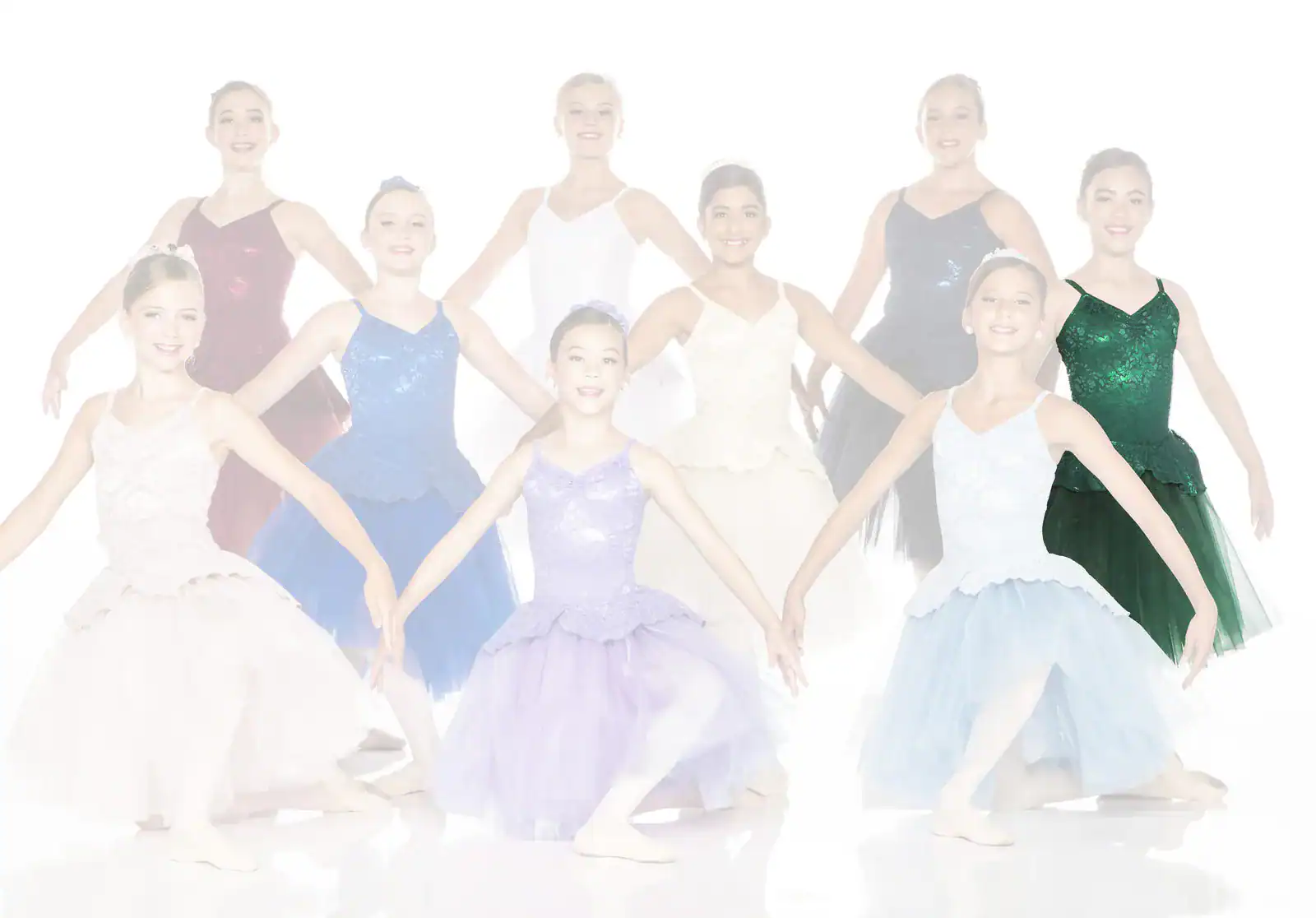 Group of young ballet dancers in colorful costumes posing