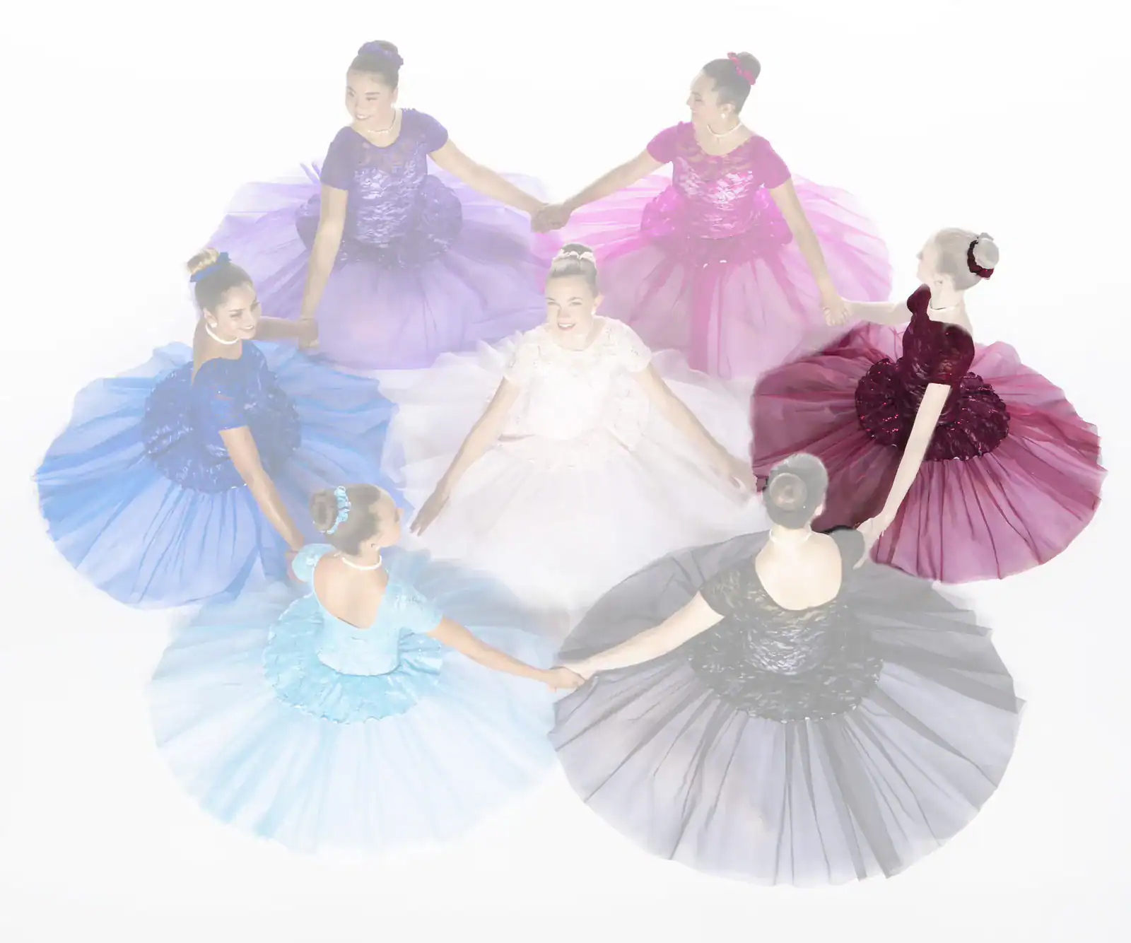 Seven dancers in colorful dresses hold hands in a circle.