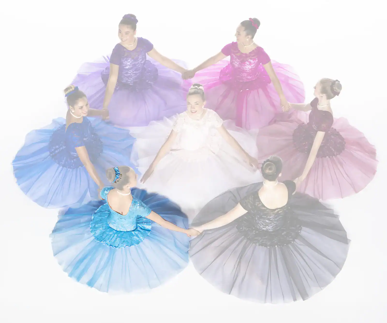 Seven dancers in colorful gowns holding hands in a circle
