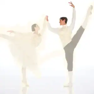 Two ballet dancers performing graceful partnered poses