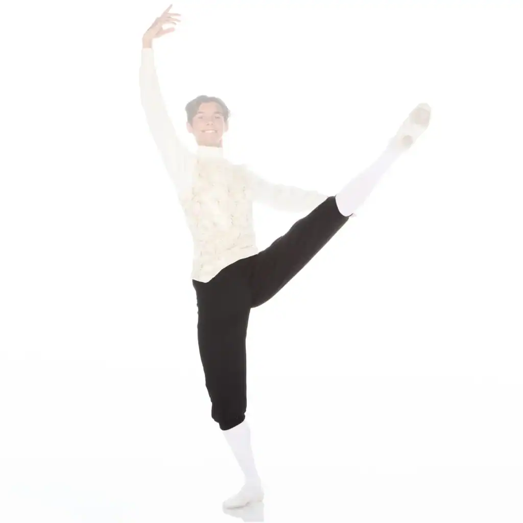 Male ballet dancer performing a high leg extension