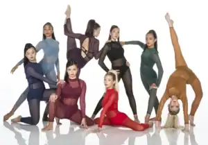 Seven dancers pose in colorful sheer leotards on white background.