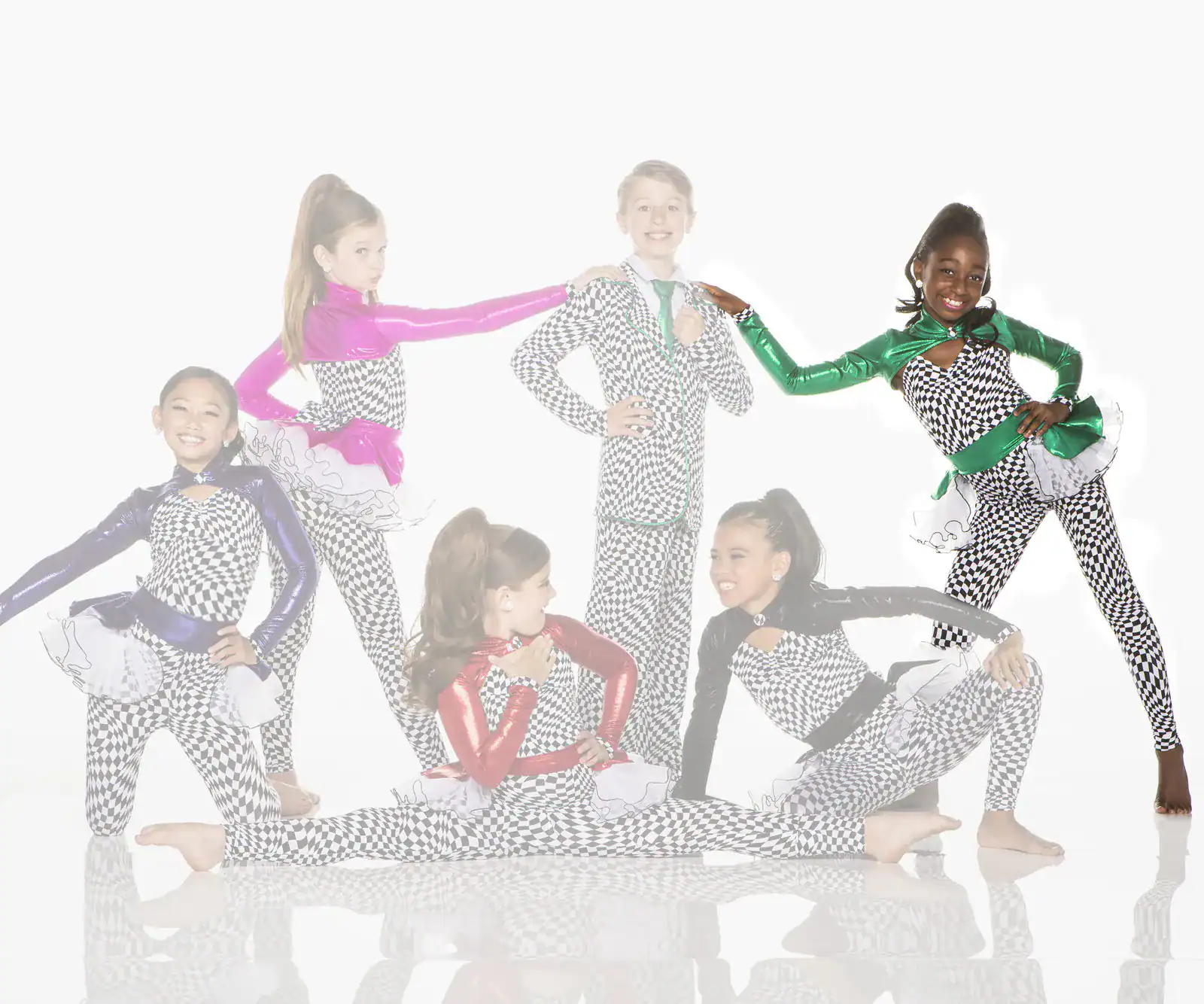 Six young dancers pose in colorful checkered costumes.