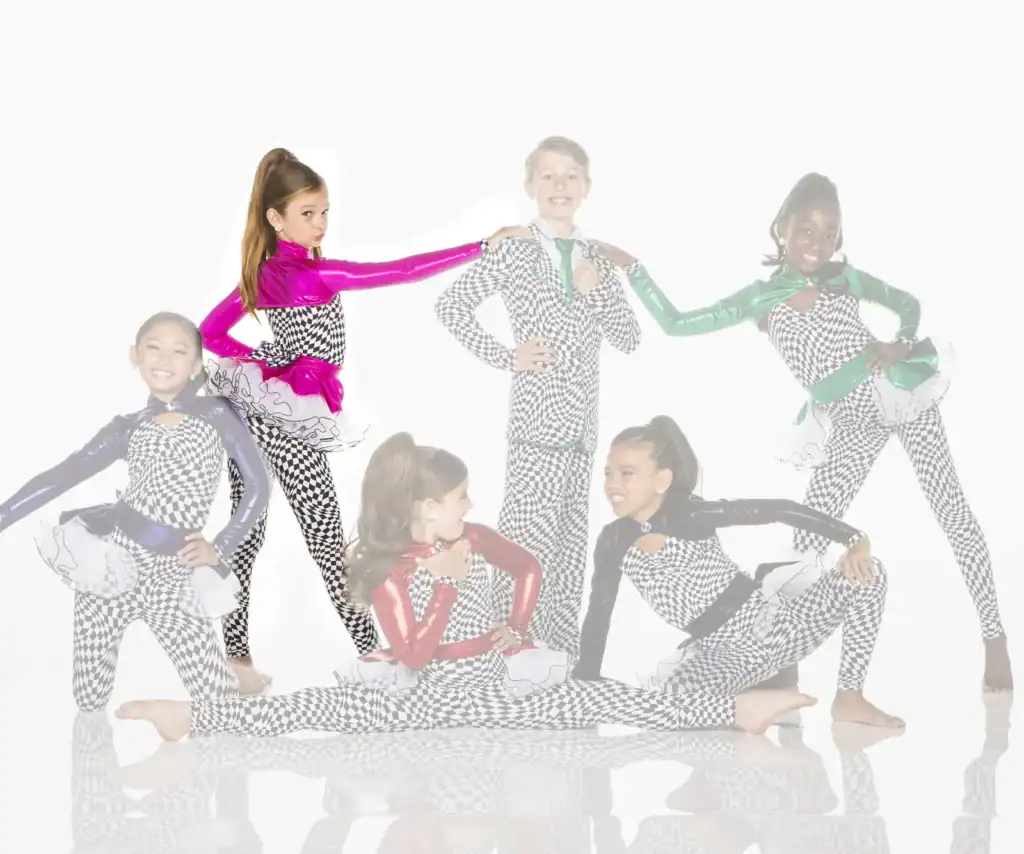Six young dancers posing in checkerboard costumes and colorful jackets
