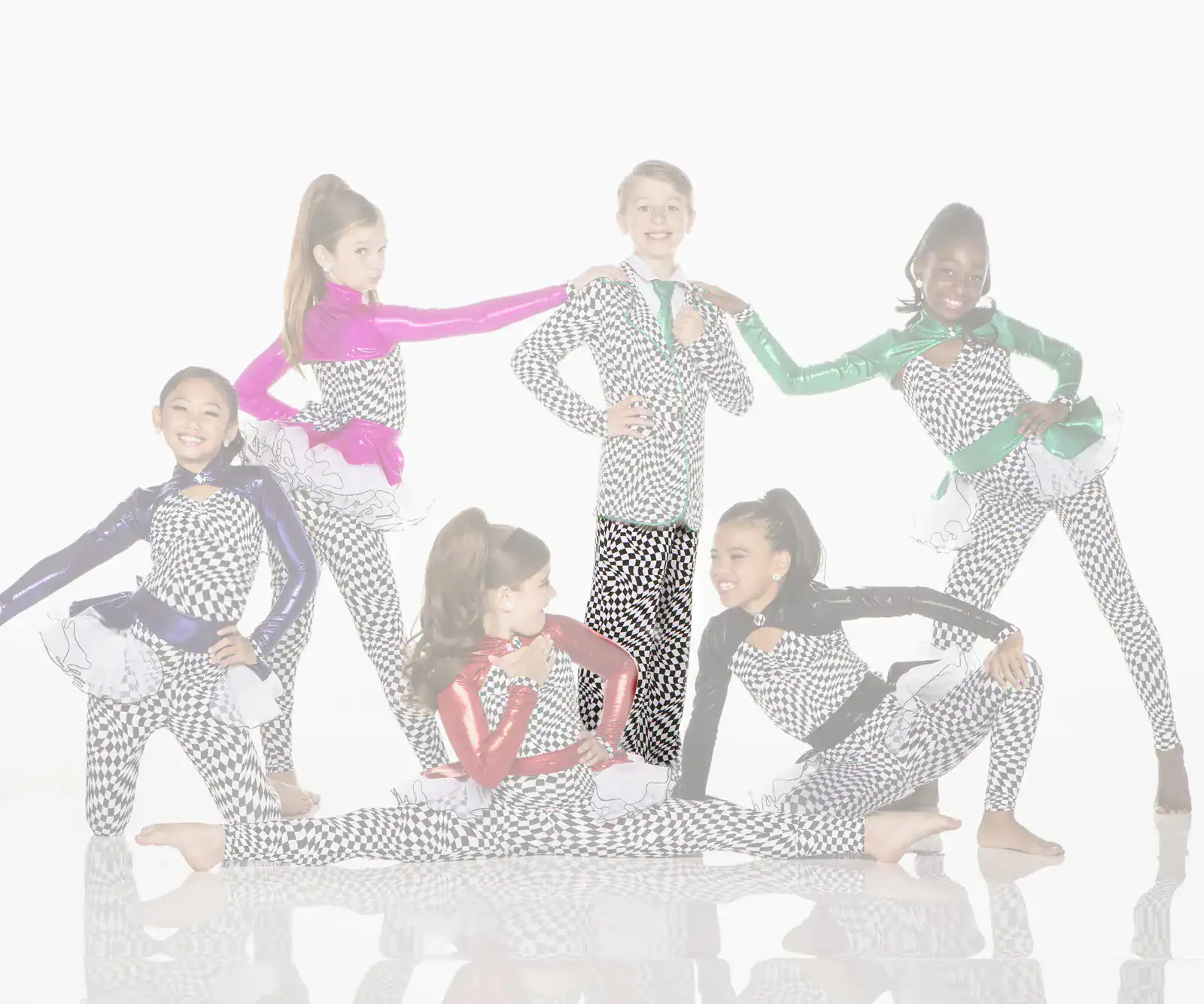 Six young dancers pose in colorful checkerboard costumes.