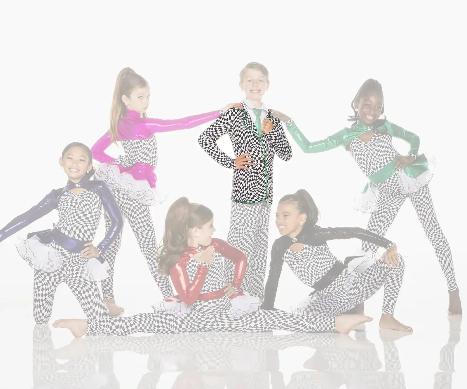 Six young dancers in colorful checkered costumes posing together