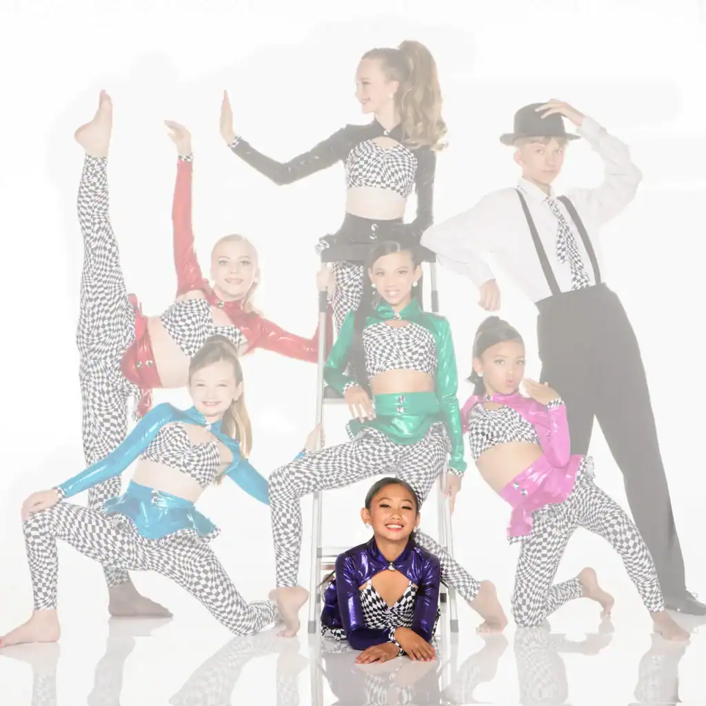 Youth dance team posing in colorful checkered costumes