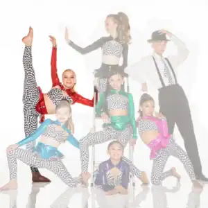 Young dancers pose in colorful checkered costumes against white backdrop