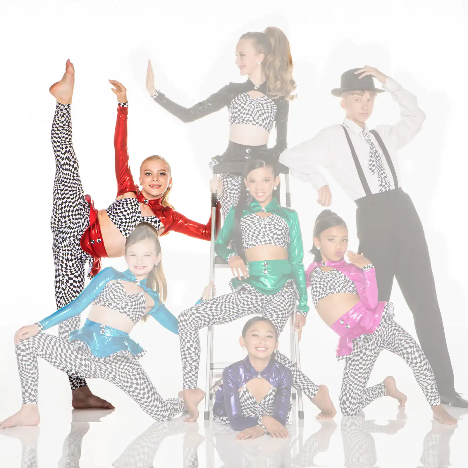Young dancers pose in colorful checkered costumes against white backdrop