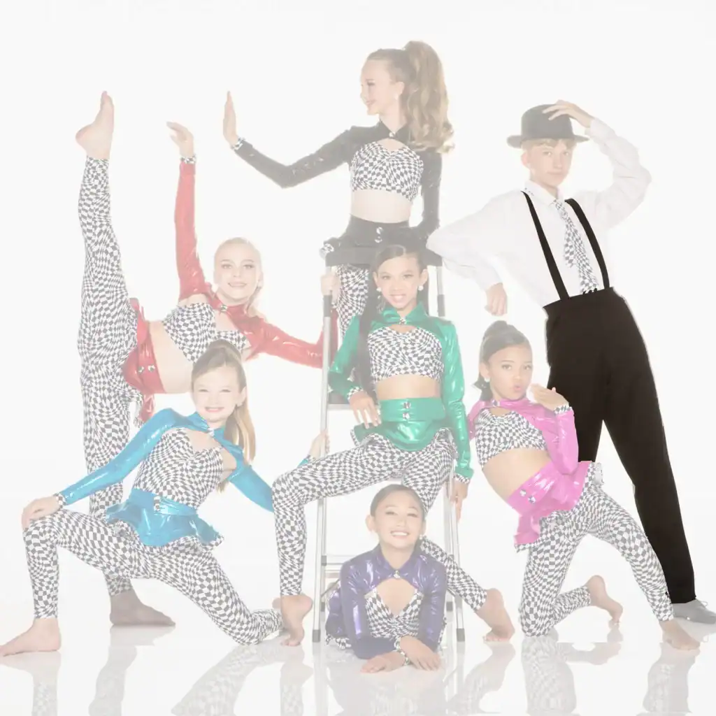 Young dancers pose in colorful checkered costumes with a male performer.