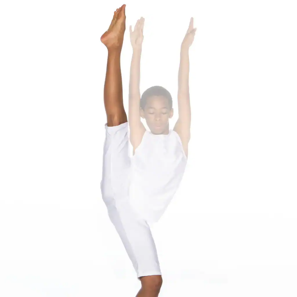 Dancer in white performing a high leg extension
