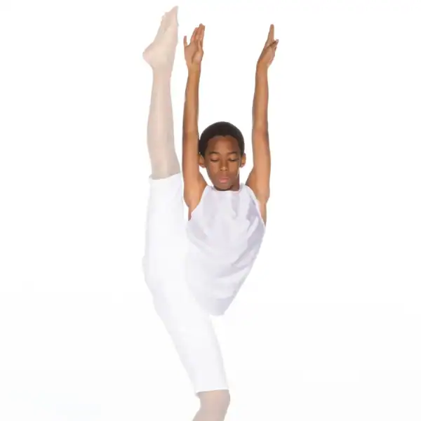 Young dancer in white performing an overhead leg stretch