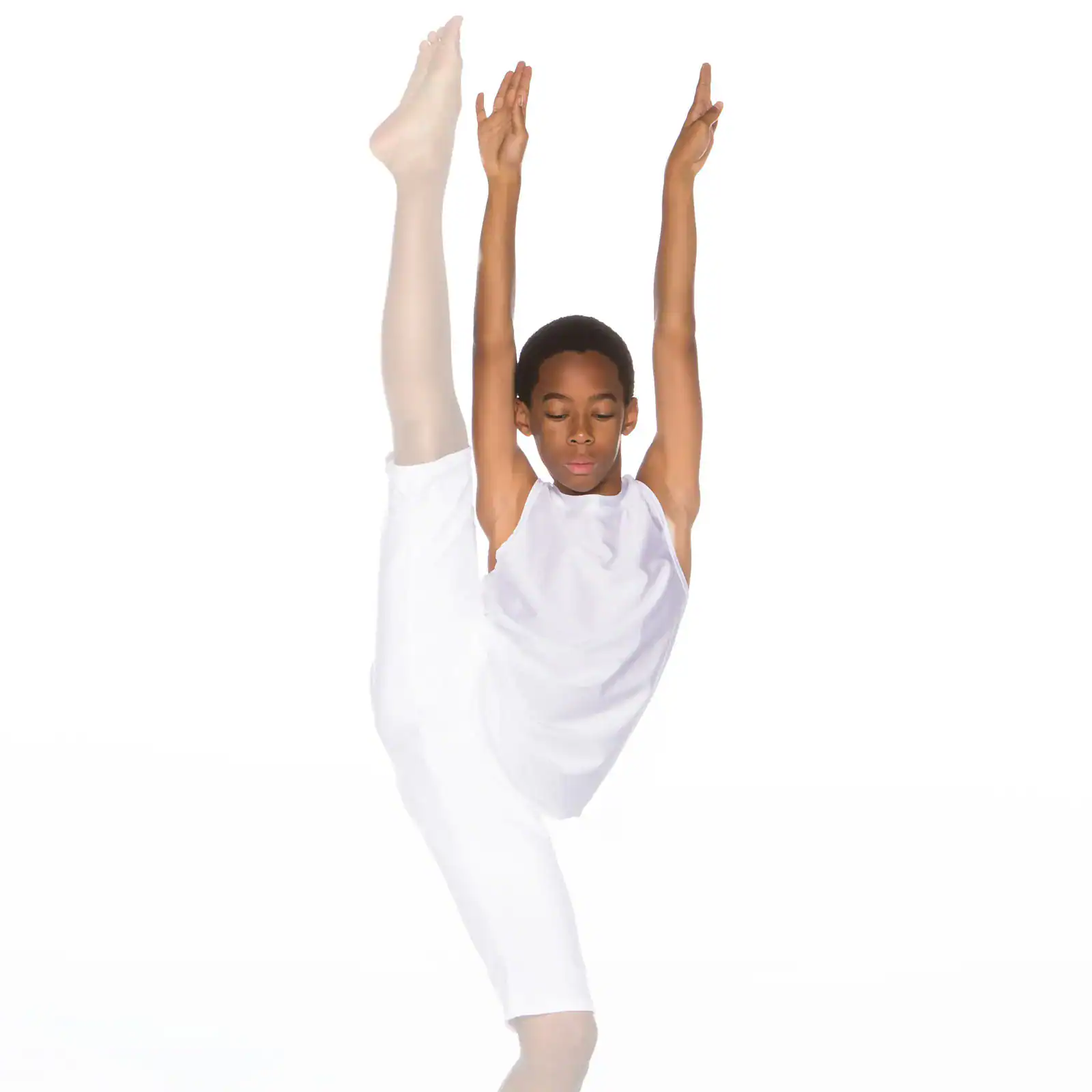 Young dancer in white performing an overhead leg stretch