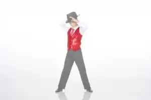 Boy in red sequined vest tipping black cowboy hat