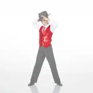 Boy in red sequined vest tipping black cowboy hat
