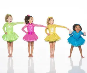 Four girls in colorful polka-dot dance dresses pointing playfully