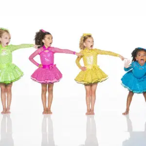 Four girls in colorful polka-dot dance dresses pointing playfully