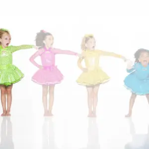 Four girls in colorful polka-dot dance costumes posing playfully