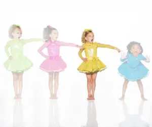 Four girls in colorful polka-dot dresses pointing right