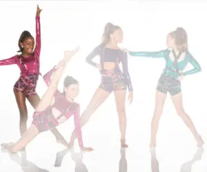 Four young dancers posing in colorful metallic costumes