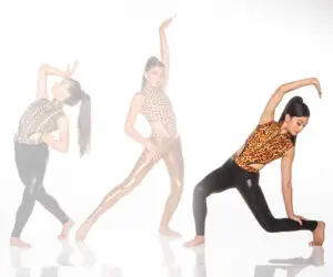 Three women posing in animal-print dance outfits
