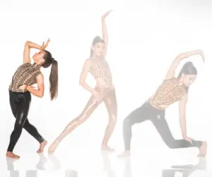 Three women posing in animal-print dancewear on white background