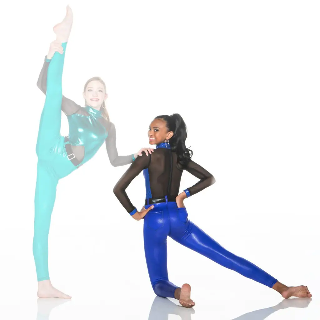 Two young dancers perform splits in colorful costumes.