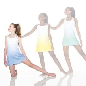Three dancers in pastel dresses pose against a white background.