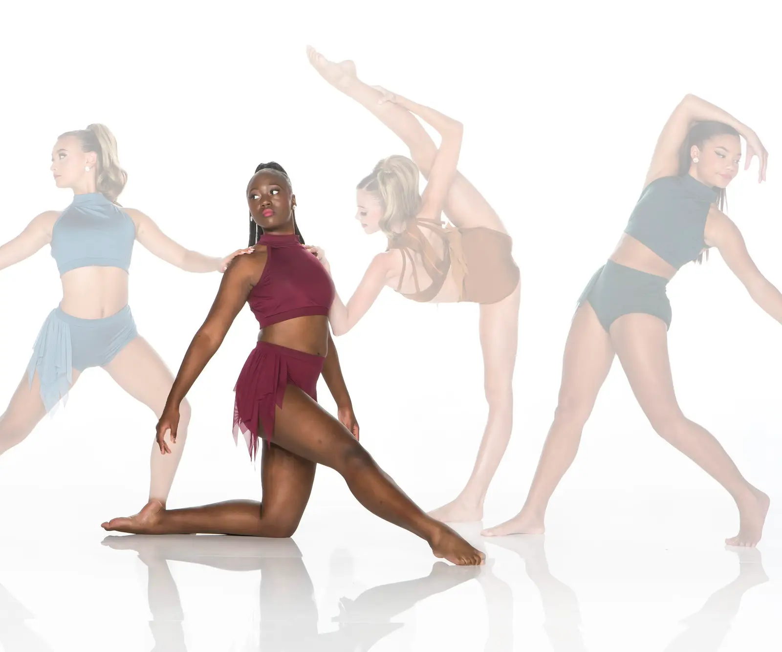 Four contemporary dancers posing against a white studio background