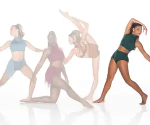 Four female dancers posing in colorful costumes on white background