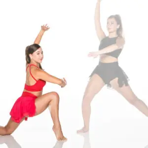 Two dancers posing in red and black costumes