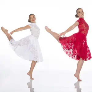 Two dancers in white and red lace dresses posing