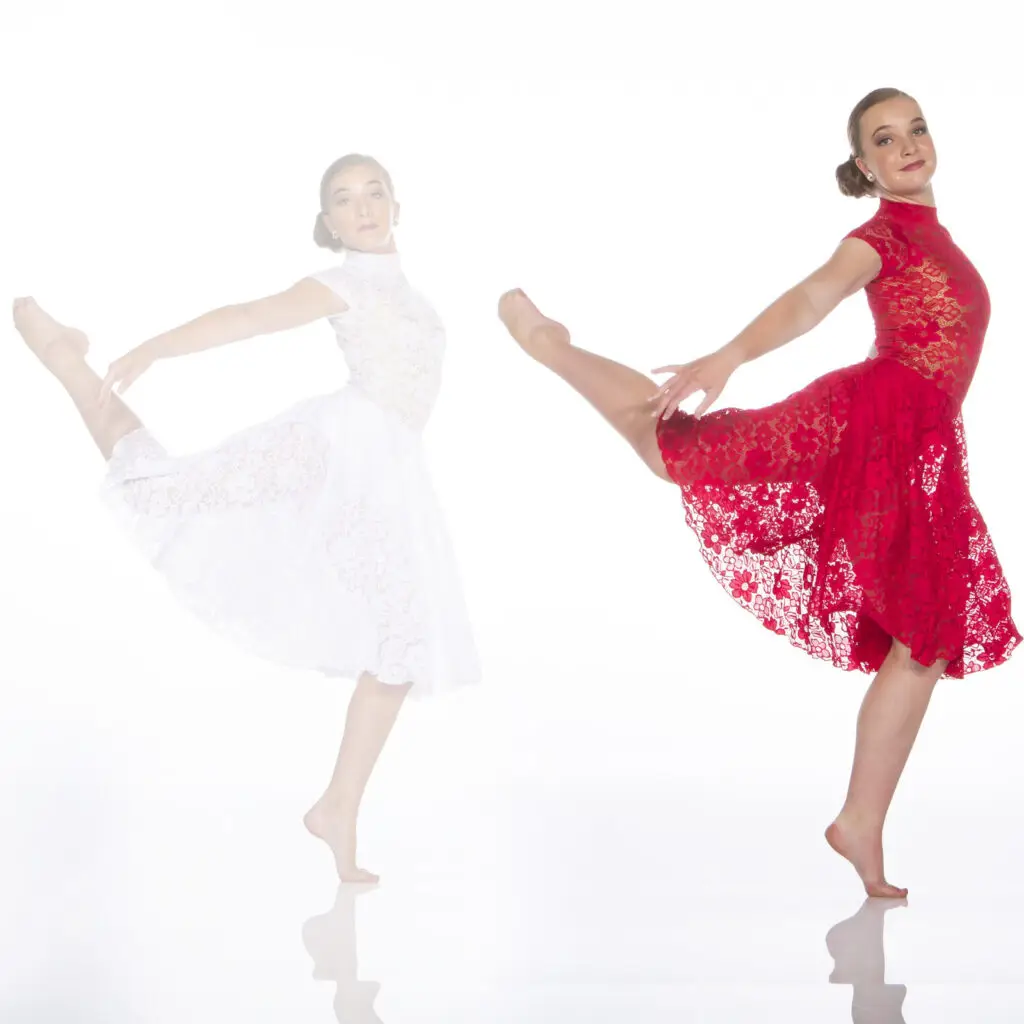 Dancer in red lace dress performing a graceful pose