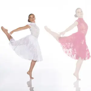 Two dancers pose in white and pink lace dresses.