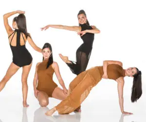 Four women pose in black and brown dancewear.