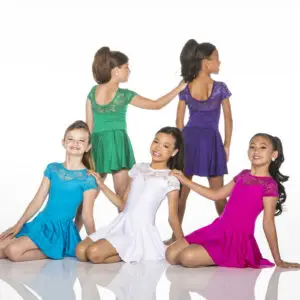 Five young dancers wearing colorful dresses pose in a studio.
