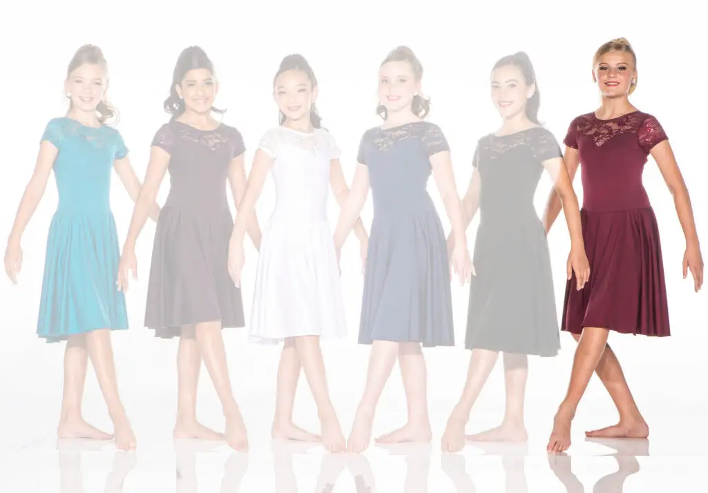 Six girls wearing colorful lace dresses stand in a row.